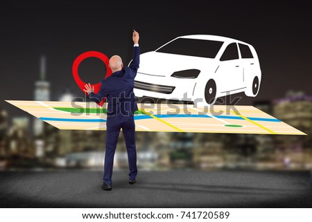 View of a Businessman in front of a wall with a Car on a map with a pin holder - GPS and localization concept