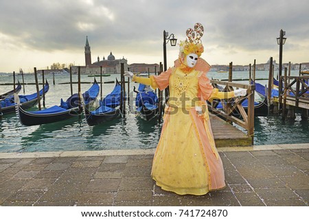 Venice, Carnival, Landscape with masks on the shore of the Grand Canal. Royalty-Free Stock Photo #741724870