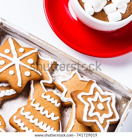 Christmas cookies in a white wooden box with hot chocolate and marshmelow, on a light background. horizontal