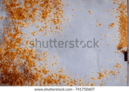 Rusty metal sheet with gray paint and stain texture background.