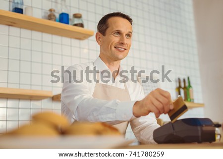 Nice good looking man holding a credit card