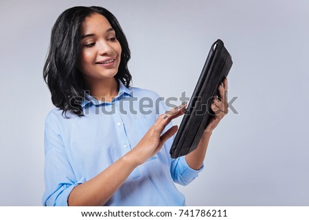 Smiling young woman using tablet