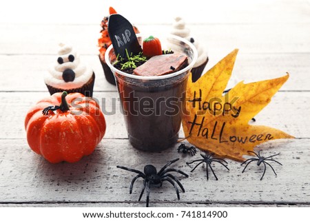 Fresh halloween gingerbread cookies with candies on wooden table