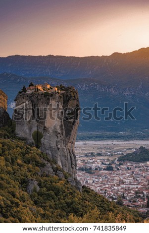Beautiful aerial panoramic photo of the monasteries and rock formations of Meteora above Kalampaka city at sunset. Thessaly, Greece, Europe.
