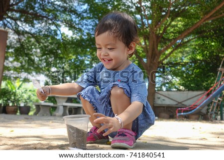 Asian baby girl playing in playground.