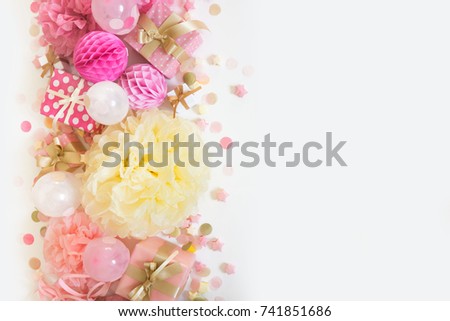 Pink and gold confetti, tinsel, serpentine and gifts. White background.