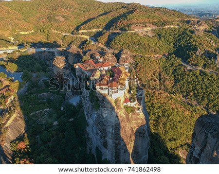 Beautiful airplane tele-photo view the monasteries and rock formations of Meteora above Kalampaka city at sunset. Thessaly, Greece, Europe.