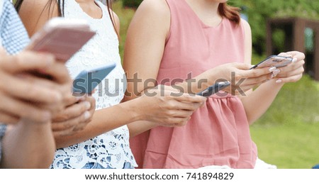 People using cellphone in the park 