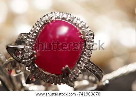 High Value Gems Stone accessories, Gold, Diamond, Ruby ring on holder. Studio lighting dark bokeh background, HDR stacking macro photo