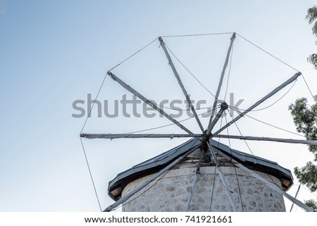 Close detailed view of ancient stone windmill on clean blue sky background in Alacati town, a popular destination for traveling and holiday in Izmir,Turkey.Copy space for editing.