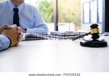 Legal counsel presents to the client a signed contract with gavel and legal law. justice and lawyer concept Royalty-Free Stock Photo #741939232