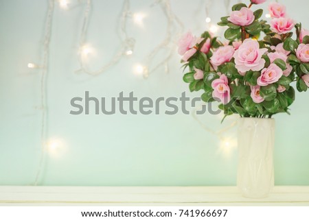 Sweet soft pastel pink korea style flower in white vase on wooden table decoration spakling light wall for valentine or anniversary important day with copy space for text or image.