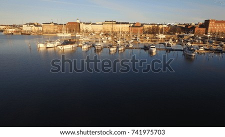 4K aerial view drone photo of Helsinki bay area near sea terminal Katajanokka and harbour with city skyline, moored boats and vessels and Baltic Sea view in the capital of Finland, northern Europe