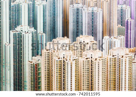 Colorful Pastel Crowded Buildings estate in Hong Kong city scape in misty gloomy day.