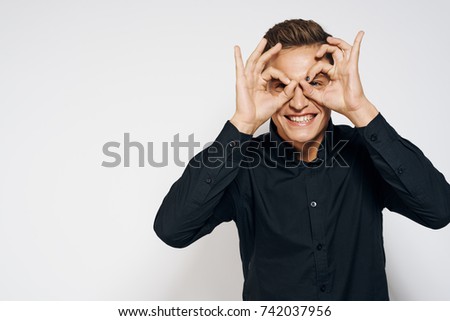 business man smiling holding his fingers near the eyes, zani, studio, emotions                               