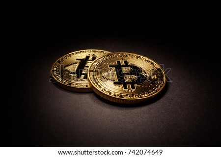 Golden Bitcoins Coins on black background. Bitcoin cryptocurrency. Business concept.