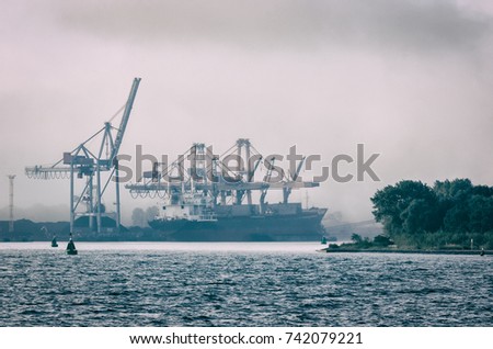 SHIP IN A SEA PORT - Transshipment terminal in the mist