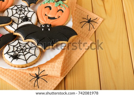 Halloween. Sweet gingerbread on a napkin and spiders. View from above