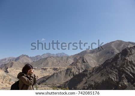 Asia woman with backpack taking photo of a beautiful mountain.