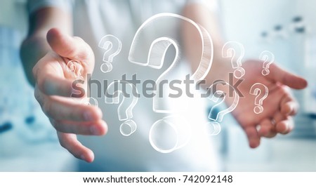 Businessman on blurred background holding hand drawn question marks Royalty-Free Stock Photo #742092148