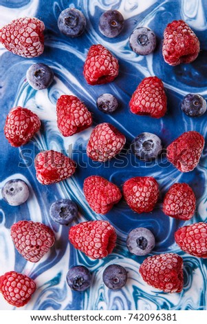 Photo on top of frozen blueberries and raspberries