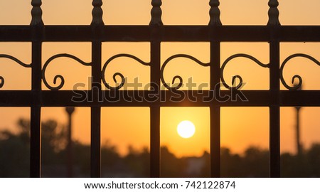 metal fence at sunset