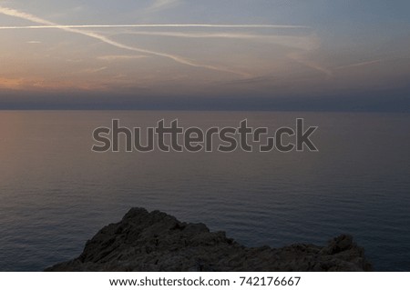 Corsica: the Mediterranean Sea, a cliff and the breathtaking sunset seen from the top of the Ile de la Pietra (Stone Island), the rocky promontory of Ile-Rousse (Red Island), city of the Upper Corsica