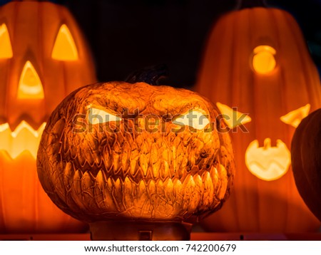 The angry face with the orange light growing inside the pumpkins for Halloween night decoration at the end of October.