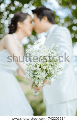 Wedding bouquet in hands of the couple