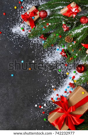 The New Year card is decorated with fir, boxes, ribbons and snow on a black background. Happy New Year and Merry Christmas!