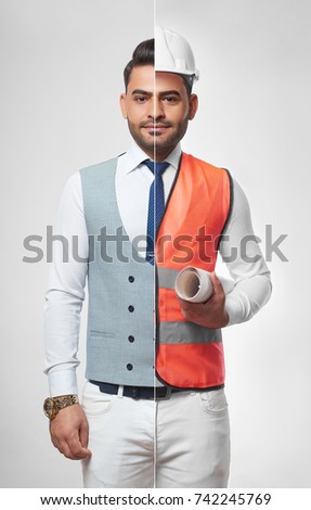 Handsome young man wearing smart casual business outfit and safety vest with a hardhat carrying a blueprint profession occupation job career architecture constructionist success CEO. Royalty-Free Stock Photo #742245769