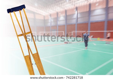 crutches for patient broken leg isolated on blurred background badminton old woman player, injury from sport concept.