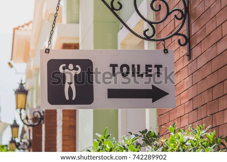 Male restroom signs mounted on the wall.