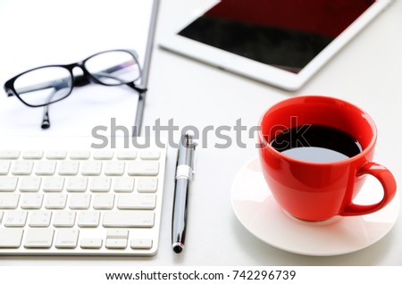 Red Coffee Cup on the desk Business Workspace background in Office Morning work