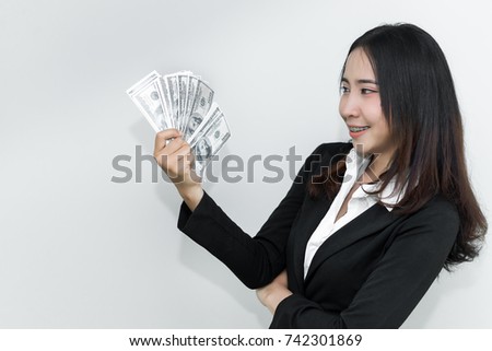 Happy business man with a lot of dollar money in hand on white background