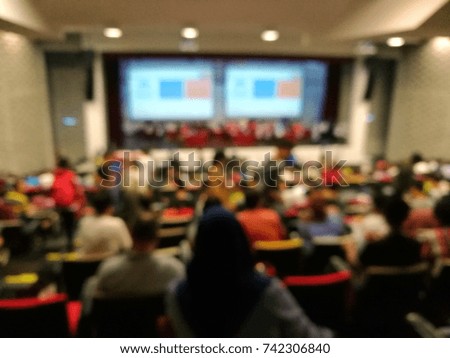 Blured background of group of  people or student attend function or class in a big hall