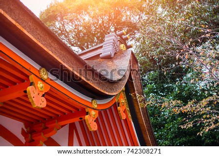 Japan style shrine red rood temple closeup roof with autumn season maple tree