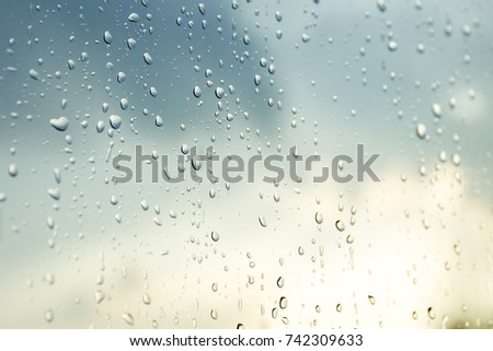 Rain drops on glass close up background.