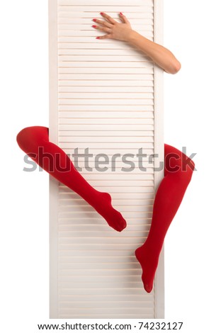 Female feet in red stockings, hands and white door