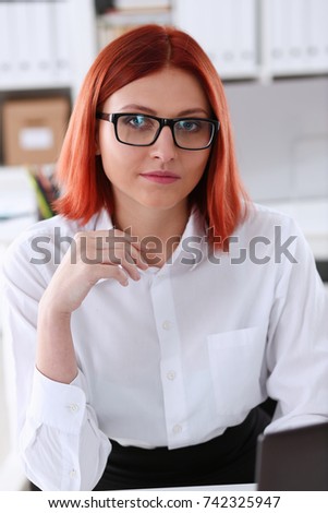 Red haired business woman with glasses