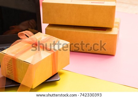 Online delivery, internet shopping, online purchase, e-commerce and packages delivery concept, Merchandise cardboard boxes on laptop key.