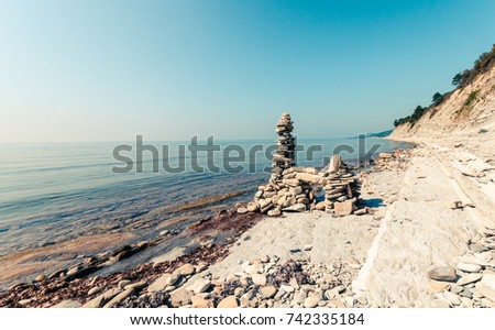 tower of stones on the sea shore, seascape