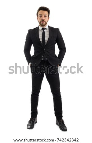Portrait of businessman. Full body photo. Person beard is wearing black suit. Elegant. White background.