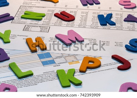 Detail of business spreadsheet, letters. Photography in studio