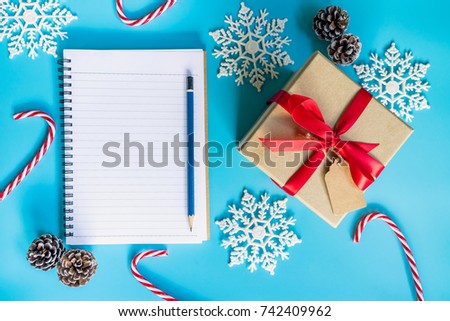 top view brown gift box, notebook and christmas decoration for new year on blue pastel color.