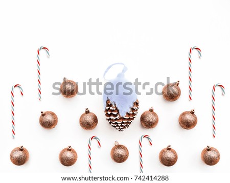 Christmas decoration, big cone and candy arranged on a white background. Greeting card, template or banner for the New Year and Christmas in a minimalist style