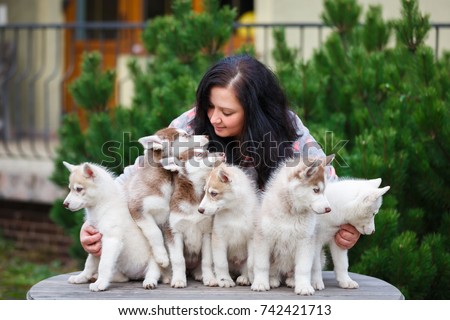 Breeder of dogs with his pets in a courtyard