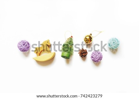 Purple, blue and golden balls, green Christmas tree, pine cone and toy wooden horse. Merry Christmas and Happy New Year greeting card and banner. Xmas gifts. Overhead photo, flat lay style, above view