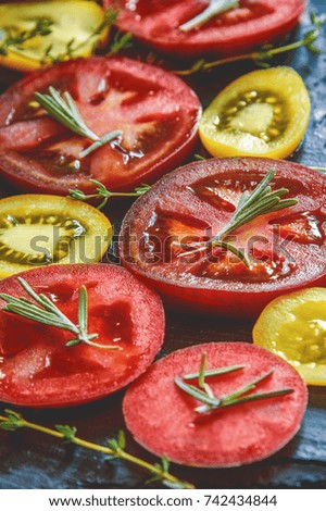 Wooden background with graphite and a round of chopped green pickled tomatoes with spices and garlic. Copy the place. The vertical frame.