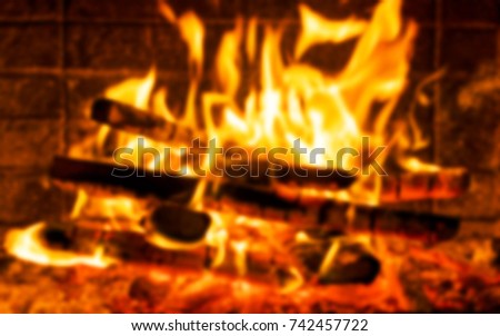 Blurred background with Burning firewood in the fireplace close up, BBQ fire, Blur charcoal background